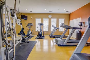 a gym with treadmills and other exercise equipment